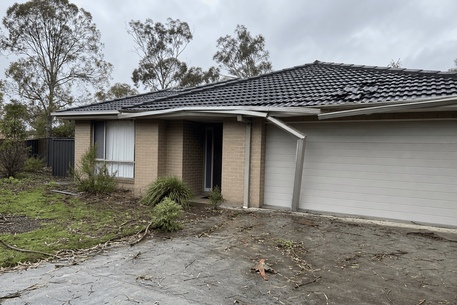 Storm-damaged gutter and roof edge on an Australian suburban home